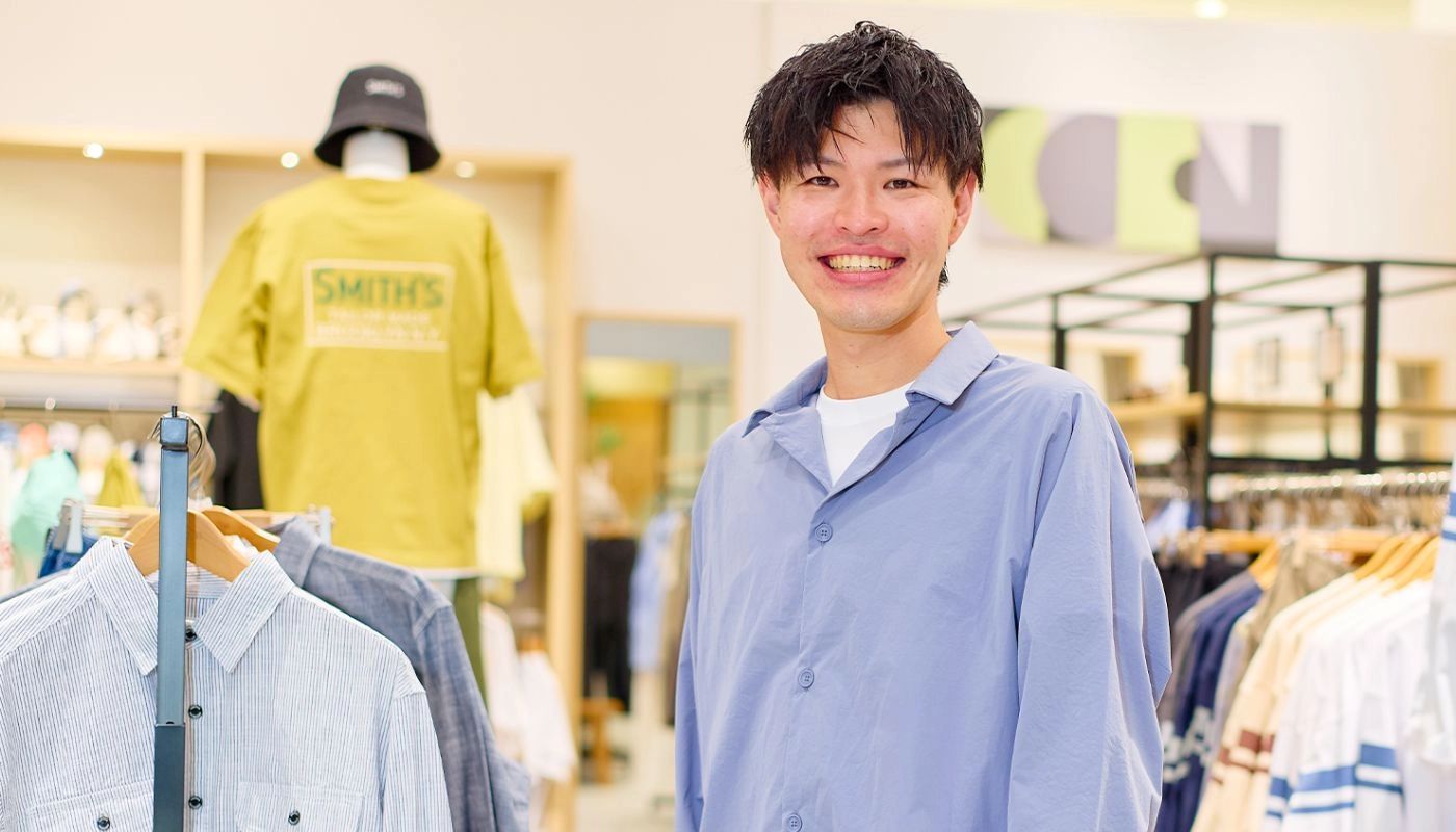 エリアマネージャー（正社員）のK.K.さんが笑顔で正面を向いている様子
